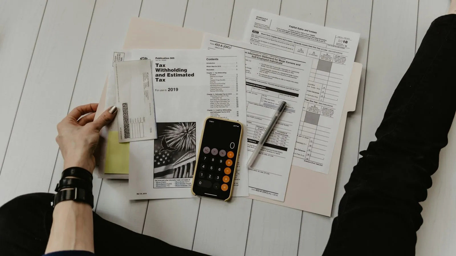 Printed accounts, a pen and a calculator on a desk